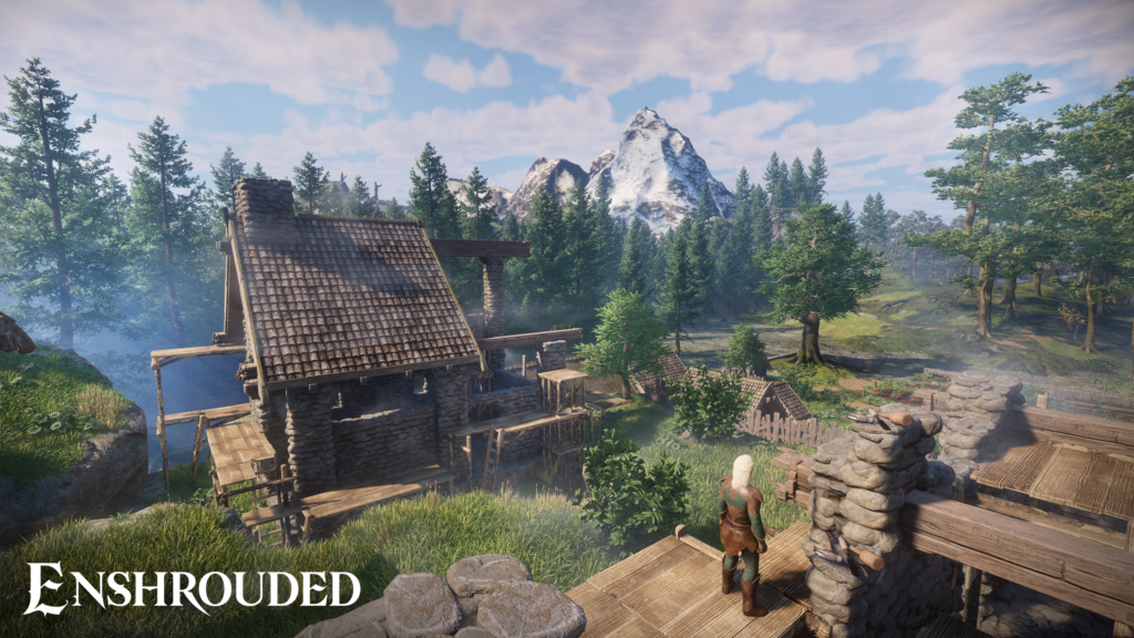 A screenshot from the game Enshrouded. The image depicts a stone house in a green forest. In the far back you can see high mountains with snow on them. In the foreground you can see a character standing on top of a wooden platform of some sorts. The character is wearing what seems to be leather armor.